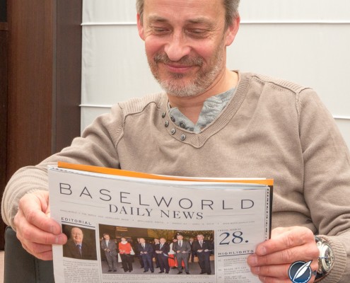 Vianney Halter reading the Baselworld News wearing his Deep Space Tourbillon