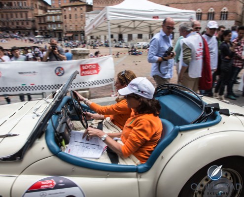 Time-check_Siena_Mille_Miglia_11793 Trinetta bas van Oisen and Ant bas van Broek driving a 1955 Triumph TR 2 Sports into Siena during the 2014 Mille Miglia
