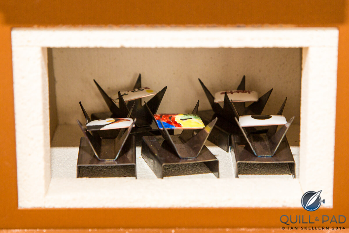 Painted enamel dials awaiting firing in the small kiln