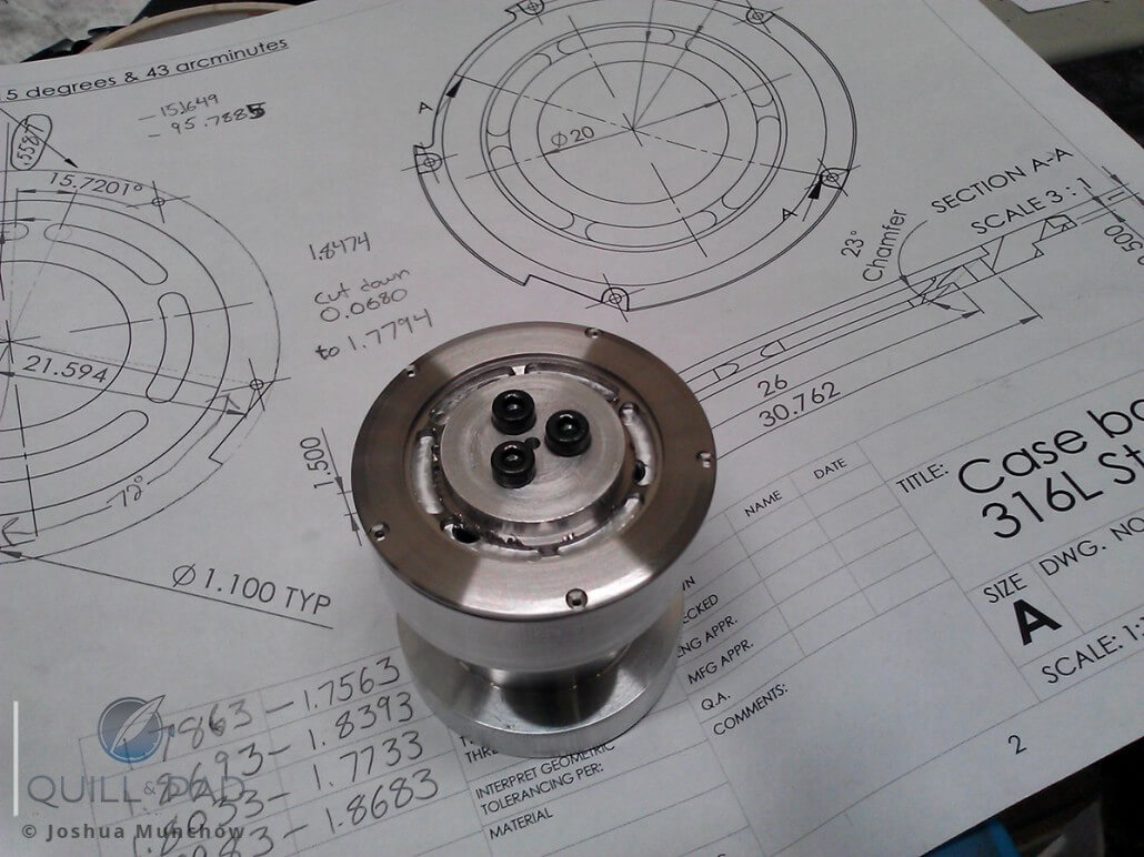 The case back of Joshua Munchow's watch on a fixture after milling, before finishing