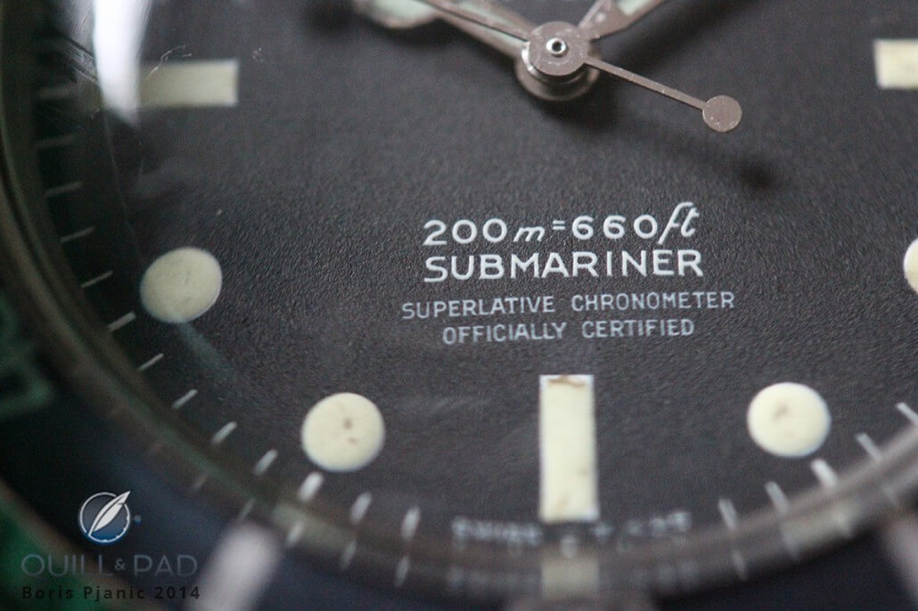 A close shot of the Rolex Submariner 5512 focusing on the four lines of pad-printed text