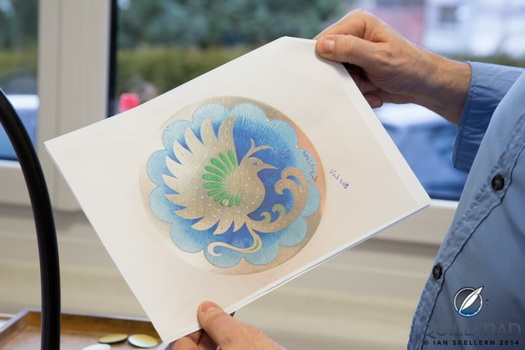 An  intricately detailed pattern of a hummingbird is first drawn on paper before being minaturized and 'transferred' to the dial 
