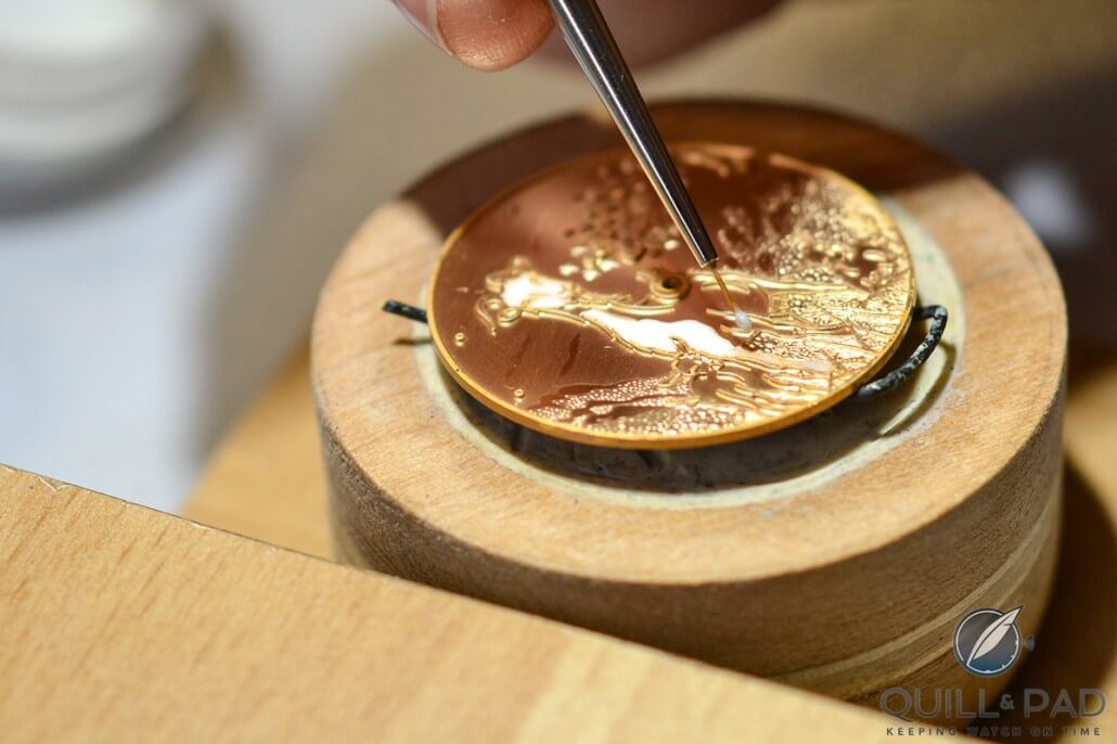Delicately applying the enamel to the champlevé dial of Ulysse Nardin's Classico Goat