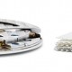 Nomos Glashütte’s automatic Caliber DUW 3001, only 3.2 mm in height, next to a small pile of stamps