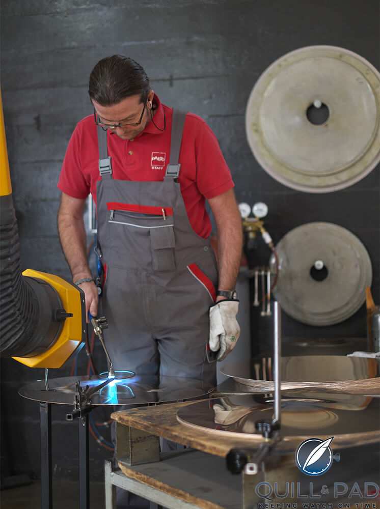 Craftsman heating a Paiste cymbal in progress at the Lucerne factory