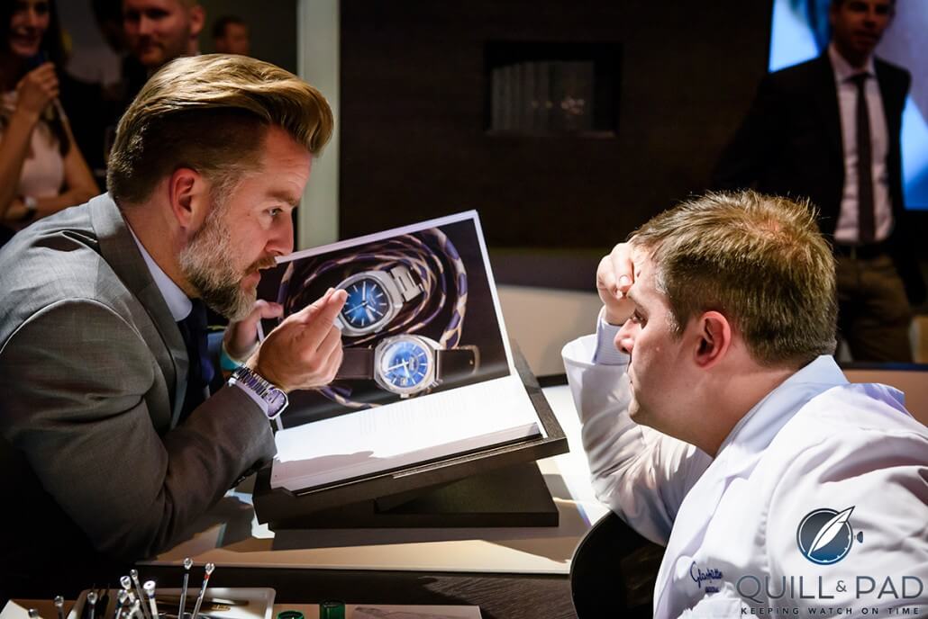 Journalist Joern Kengelbach talks to a watchmaker at the launch of the Glashütte Original book 'Impressions'