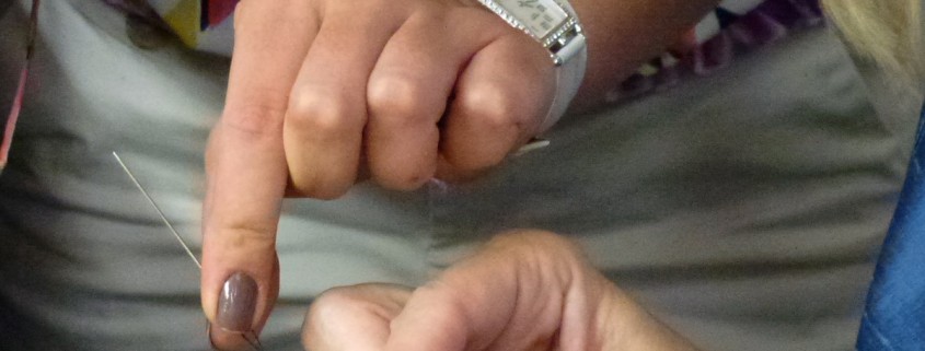 Carefully stitching the strap together under teh watchful eye of a Hermés seamstress