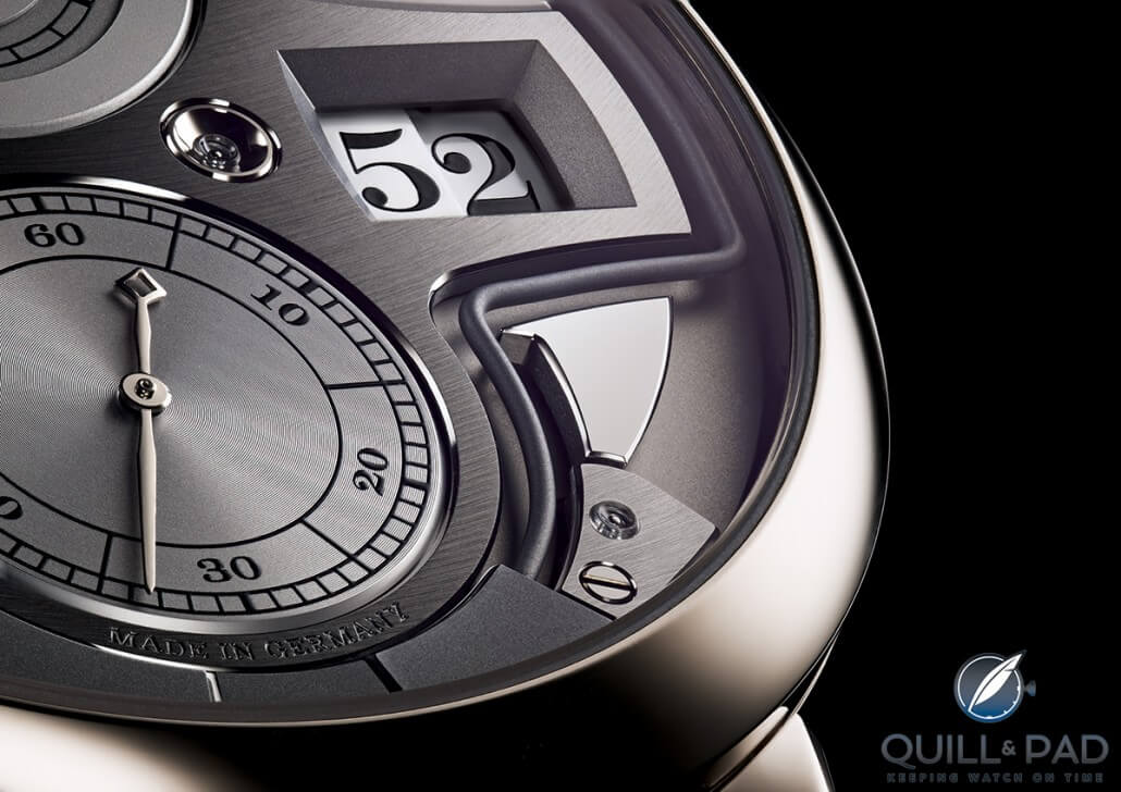 Close look at the digital minutes aperture of the A. Lange & Söhne Zeitwerk Minute Repeater with the sharply angled gong winding around below