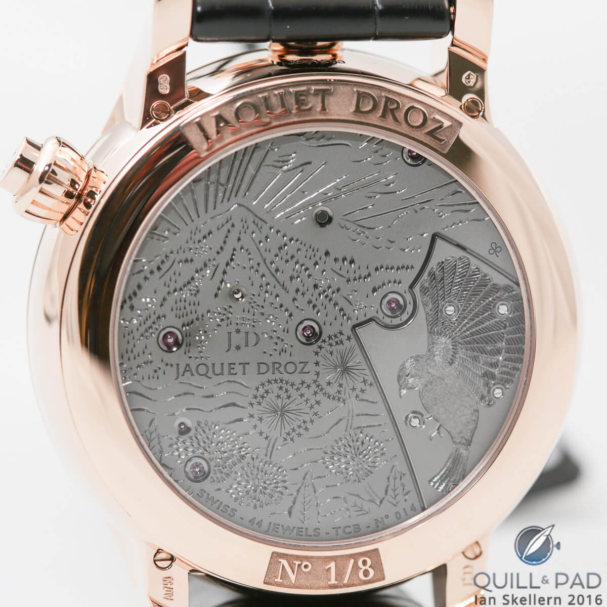 The intricately engraved back of the Jaquet Droz Charming Bird with depictions of nature in Switzerland