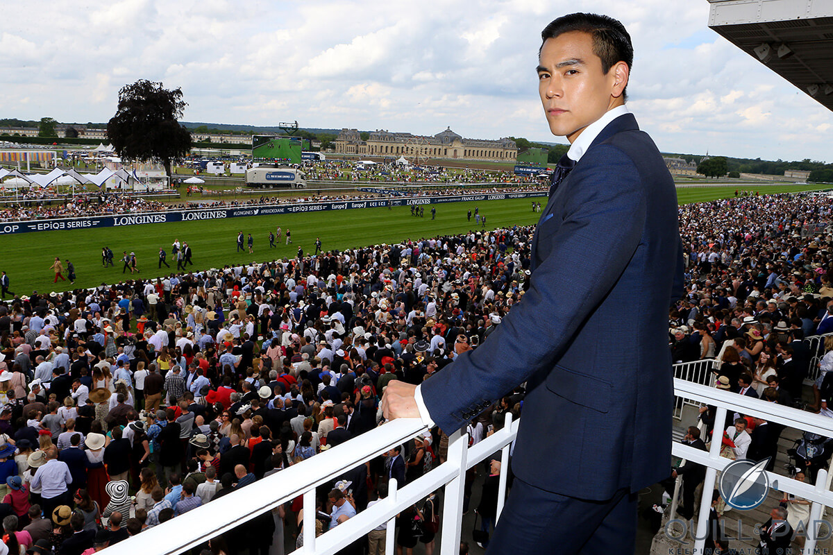 Eddie Peng overlooks the grounds of the Prix de Diane 2016 with Château de Chantilly in the background