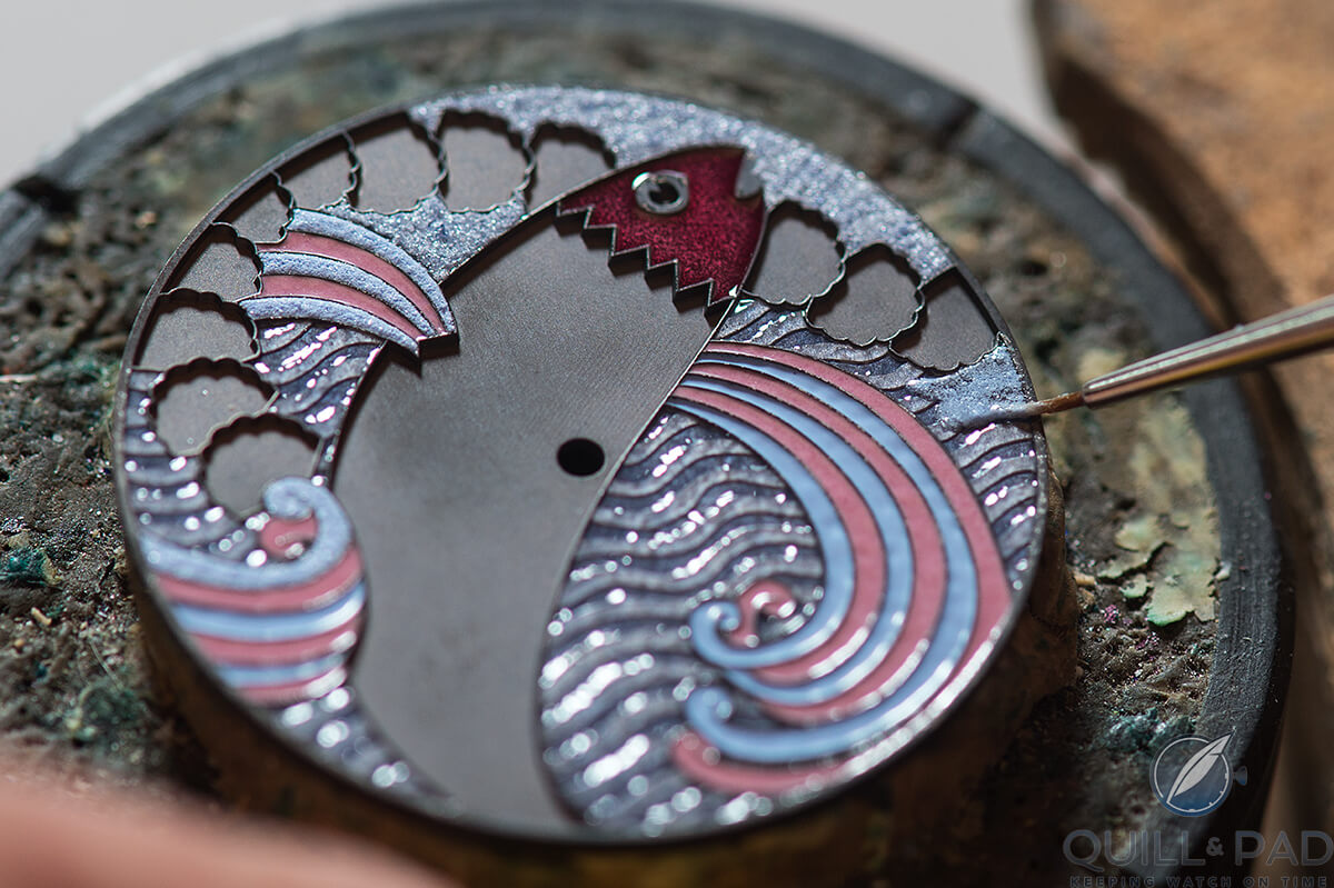 Adding enamel to the dial of the Hermès Arceau Pocket Ailes et Ecailles before firing