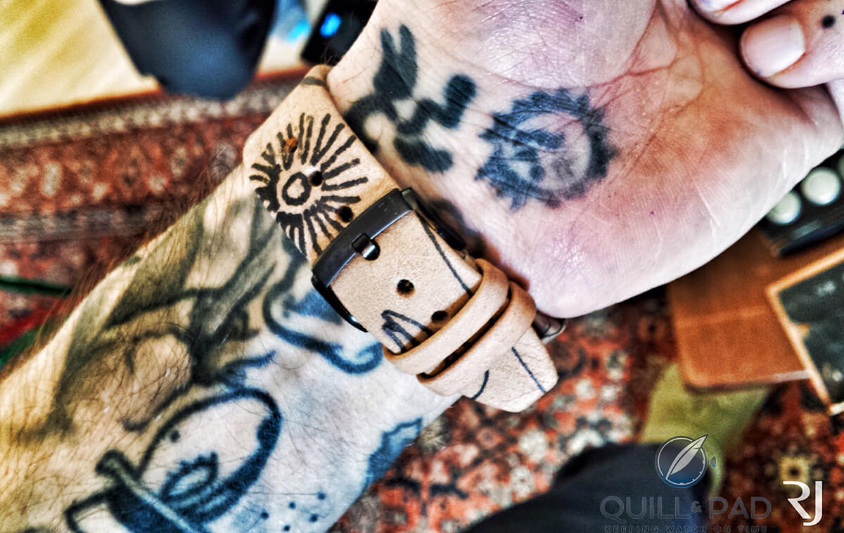 Tattooed strap of the Romain Jerome Tattoo-DNA by Xoil on a similarly tattooed arm