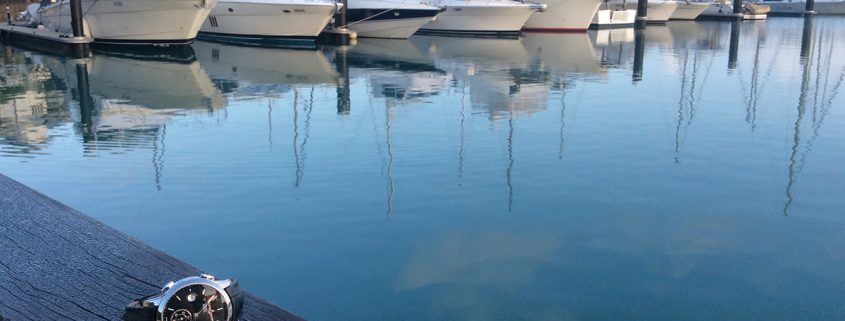 Ulysse Nardin Dual Time sitting by a dock in the bay at Airlie Beach