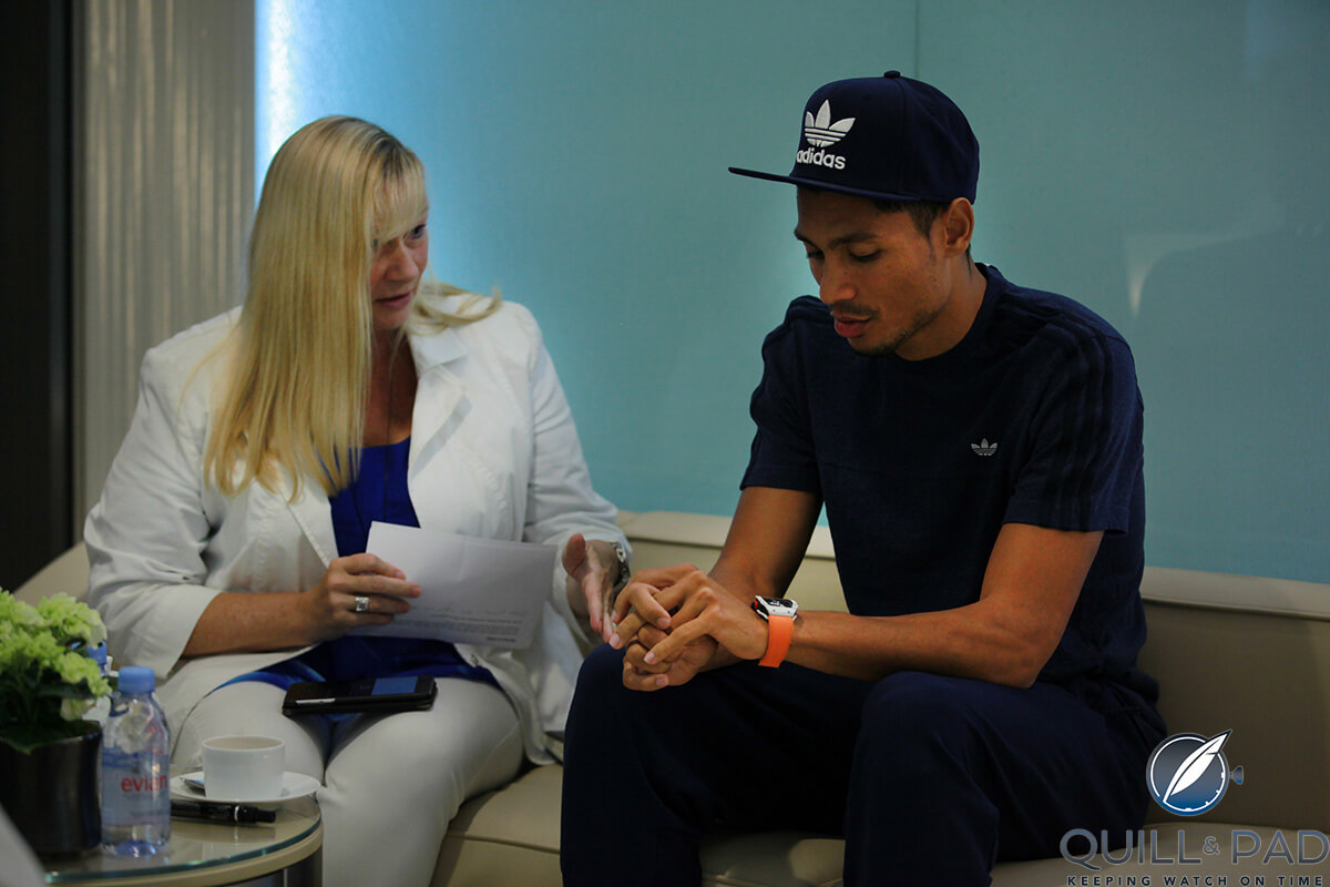 Wayde van Niekerk sneaks a look at his Richard Mille RM 27-02 Rafael Nadal while talking about it in the brand’s Paris boutique (photo courtesy Louis du Chatelle/avfactory)