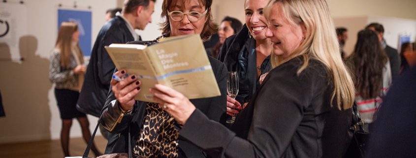 Brigitte, Nathalie and Elizabeth admiring the graphics in ‘The Magic of Watches’ by Louis Nardin