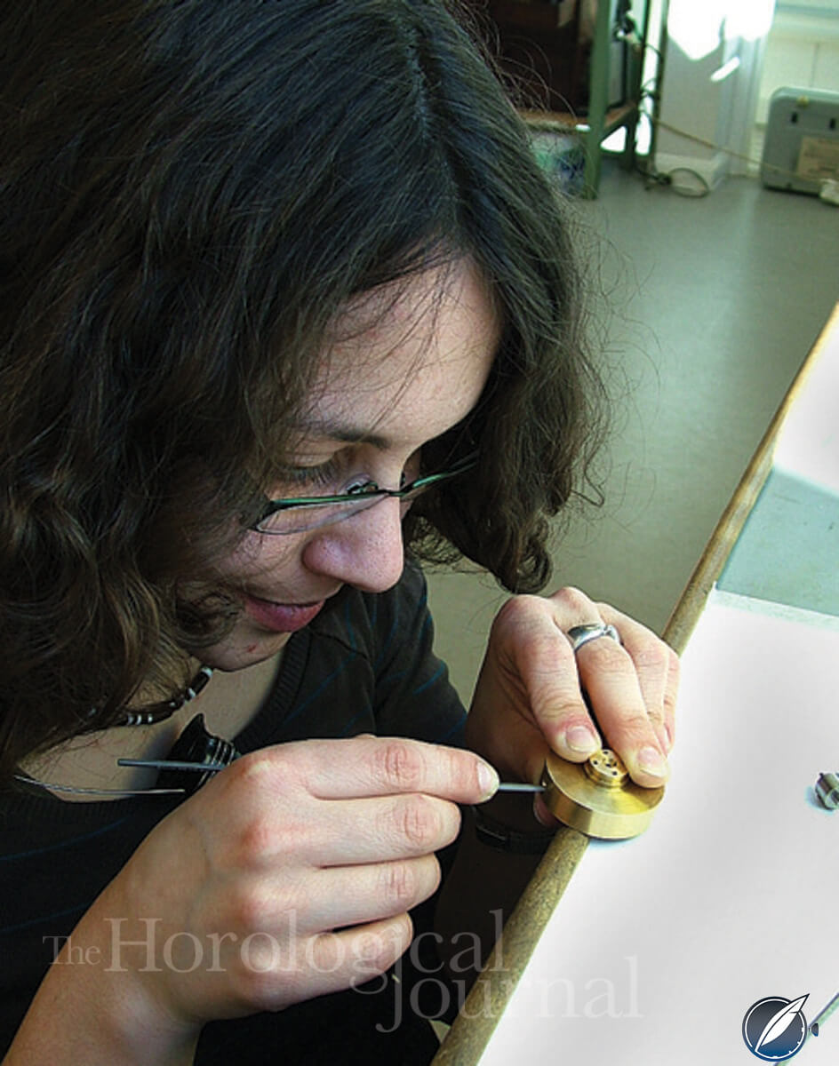Filing the mainspring hooking in the inner barrel of Derek Pratt's H4 reconstruction (photo courtesy British Horological Journal)