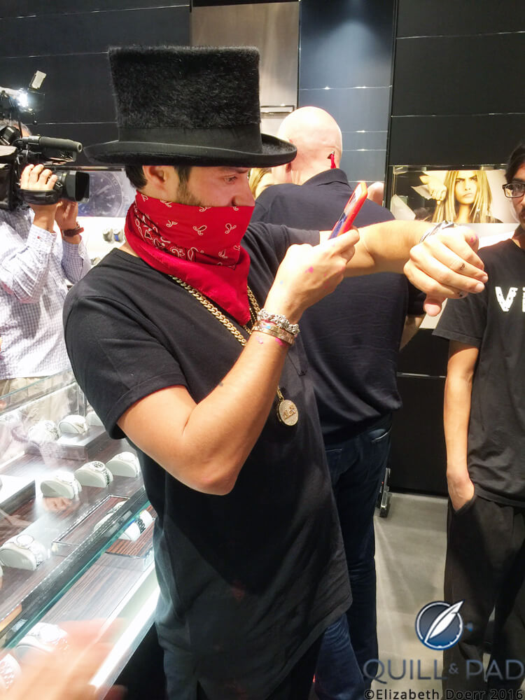 Alec Monopoly spares a moment to take a wristshot of his new TAG Heuer Carrera Heuer-02T at the Miami TAG Heuer boutique