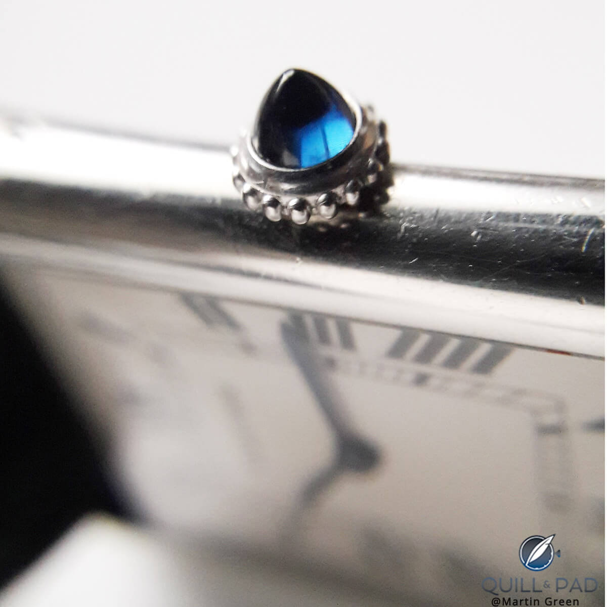 The pointed blue sapphire cabochon of Martin Green's grail Louis Cartier Tank