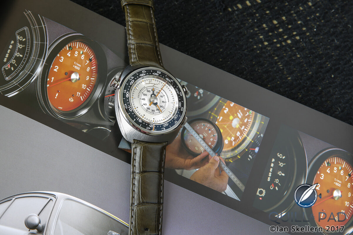 Note the center of the 911 gauges and the center of the Singer Reimagined Track 1 chronograph (background photo from the book 'More Than 10')