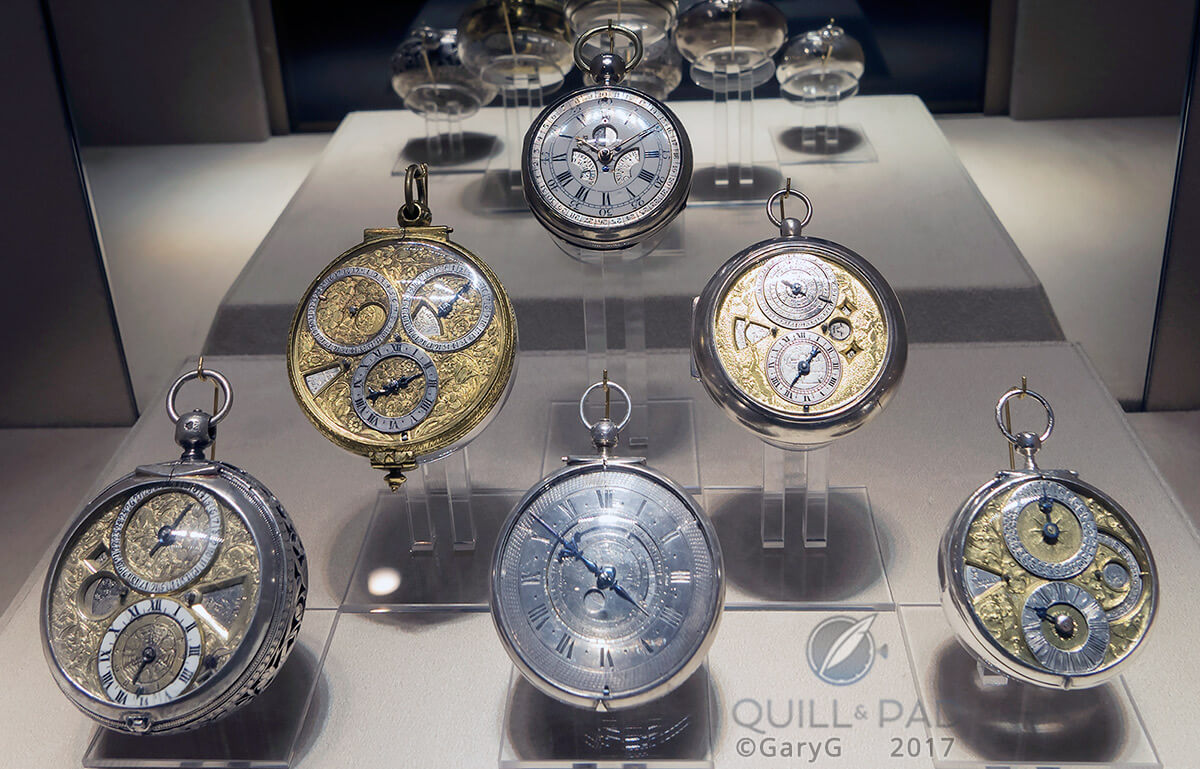 Display of antique watches including at center rear the earliest perpetual calendar, Thomas Mudge, 1762