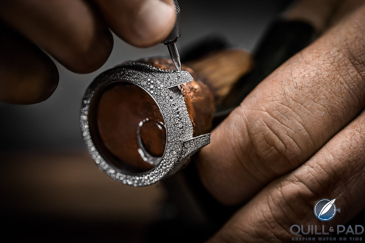 Meticulously snow setting diamonds on the case of a Dior Grand Soir Botanic
