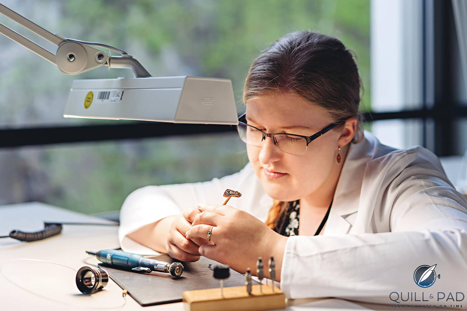 Jonna Frilander of Finland checking her engraving skills on this balance cock (photo courtesy E. Gross/A. Lange & Söhne)