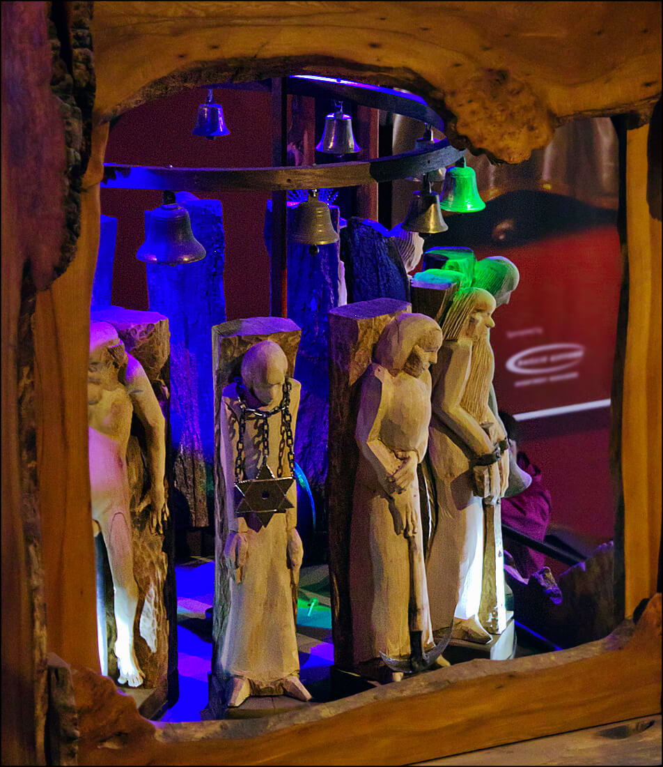 The light from the glass panels play on the requiem figures in the belfry portion of Edinburgh’s Millennium Clock Tower (photo courtesy Dun Deagh/Wikimedia)